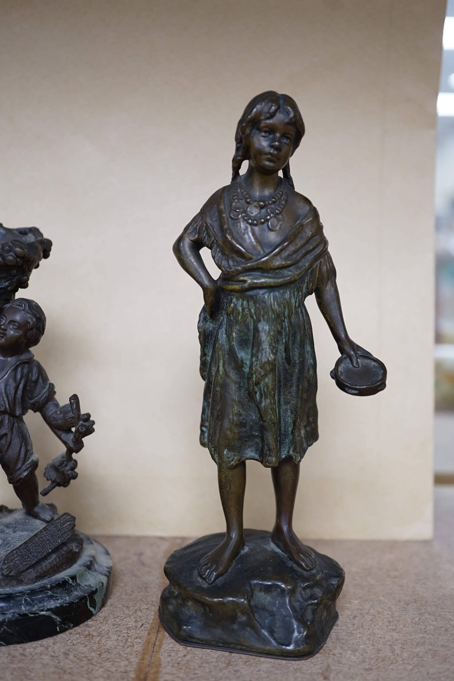 A bronze study of a girl holding a tambourine, and a bronze boy carrying grapes, raised on marble base, largest 16cm high. Condition - good